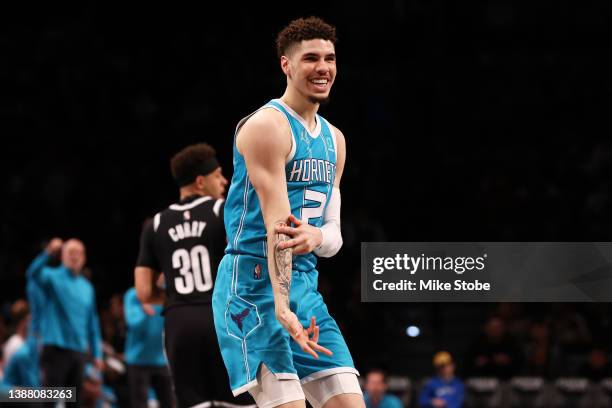 LaMelo Ball of the Charlotte Hornets celebrates after hitting a three pointer against the Brooklyn Nets at Barclays Center on March 27, 2022 in New...