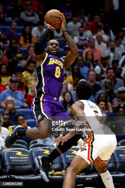 LeBron James of the Los Angeles Lakers is fouled by Herbert Jones of the New Orleans Pelicans during the third quarter of an NBA game at Smoothie...