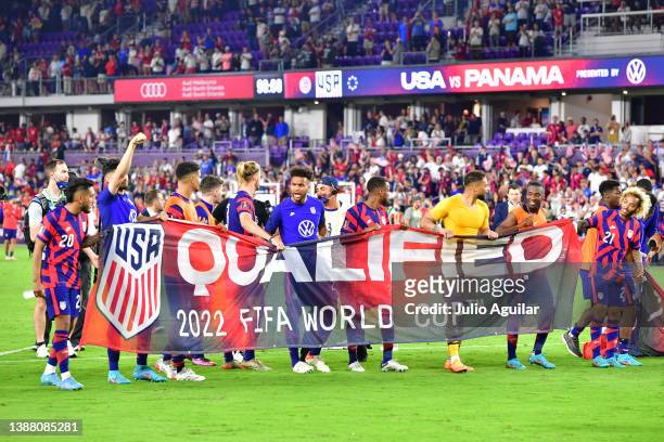 The United States Mens National Team hold a 2022 FIFA World Cup Qualified banner after defeating Panama 5-1 at Exploria Stadium on March 27, 2022 in...