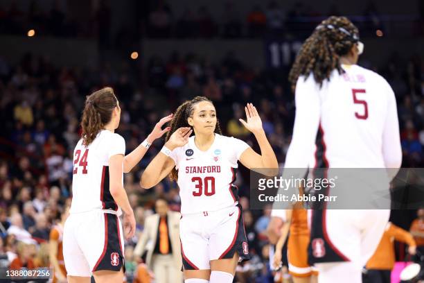 Haley Jones of the Stanford Cardinal celebrates with teammates at the end of the third quarter against the Texas Longhorns in the NCAA Women's...
