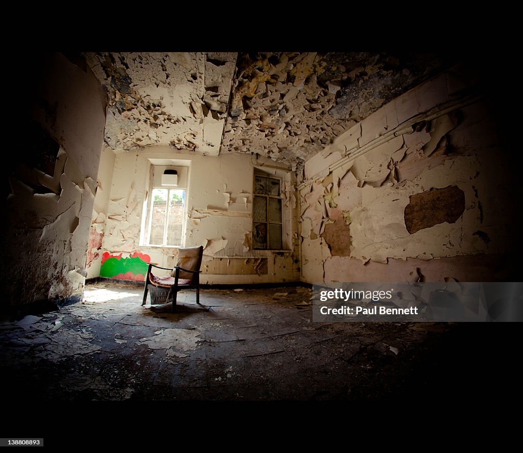 Single broken chair in derelict room