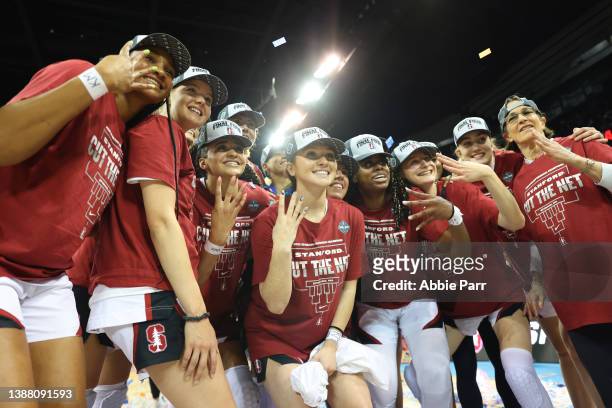 The Stanford Cardinal pose for photos after defeating the Texas Longhorns 59-50 in the NCAA Women's Basketball Tournament Elite 8 Round at Spokane...