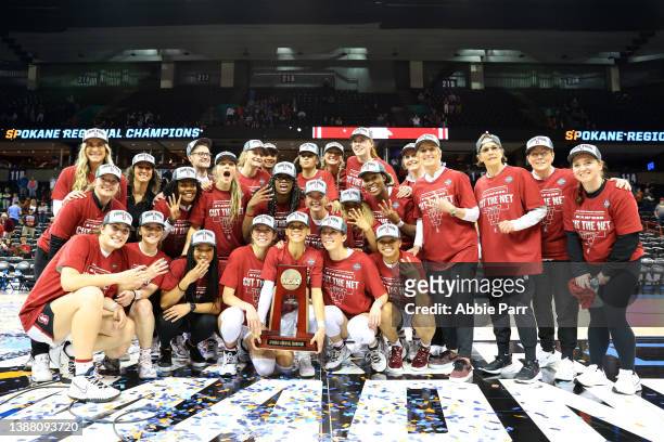 The Stanford Cardinal pose for photos with the regional champion trophy after defeating the Texas Longhorns 59-50 in the NCAA Women's Basketball...