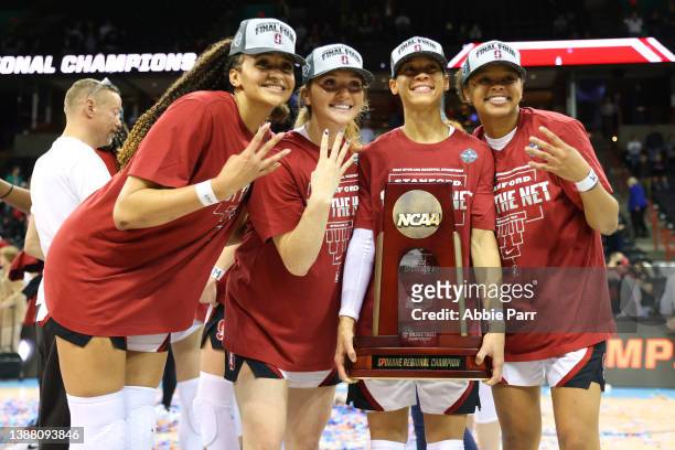 Haley Jones of the Stanford Cardinal and Anna Wilson pose for photos with teammates after defeating the Texas Longhorns 59-50 in the NCAA Women's...