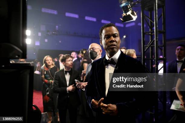 In this handout photo provided by A.M.P.A.S., Elliot Page, J.K. Simmons and Chris Rock are seen backstage during the 94th Annual Academy Awards at...