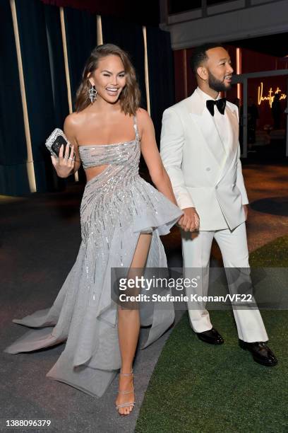 Chrissy Teigen and John Legend attend the 2022 Vanity Fair Oscar Party hosted by Radhika Jones at Wallis Annenberg Center for the Performing Arts on...