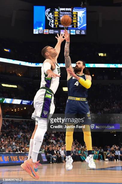 Steven Adams of the Memphis Grizzlies shoots against Brook Lopez of the Milwaukee Bucks during the game at FedExForum on March 26, 2022 in Memphis,...