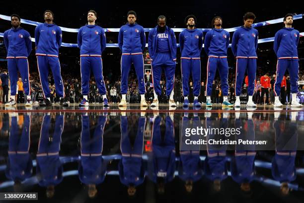 The Philadelphia 76ers stand attended for the national anthem before the NBA game at Footprint Center on March 27, 2022 in Phoenix, Arizona. NOTE TO...