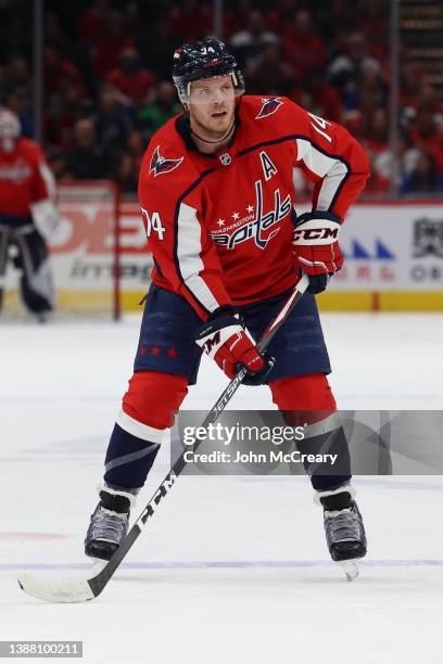 John Carlson of the Washington Capitals controls the puck during a game against the Dallas Stars at Capital One Arena on March 20, 2022 in...