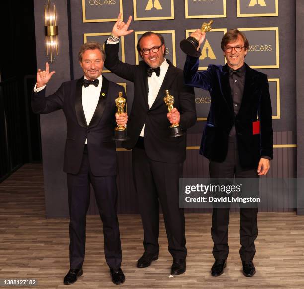 Patrick Wachsberger, Fabrice Gianfermi, and Philippe Rousselet, winners of the Best Picture award for ‘CODA,’ pose in the press room at the 94th...