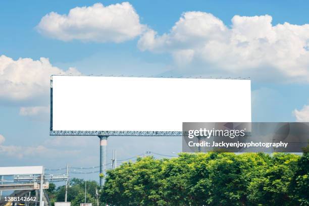 blank advertising screen against soft blue sky - billboard fotografías e imágenes de stock