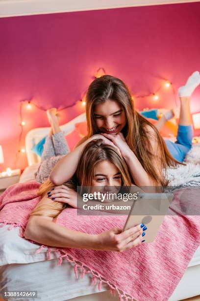 teenage girls using tablet at slumber party - sleepover bildbanksfoton och bilder