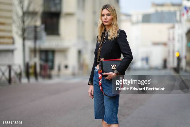 Natalia Verza wears a black felt with brown LV monogram print pattern in coated canvas borders cropped jacket from Louis Vuitton, high waist blue...