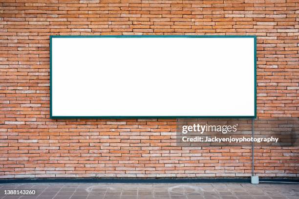 blank billboard on brick wall - lightbox stock-fotos und bilder