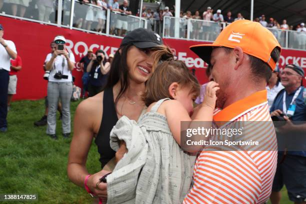 Golfer Rickie Fowler holding his daughter Maya Fowler and with his wife Allison Stokke on July 2 after the final round after winning the Rocket...
