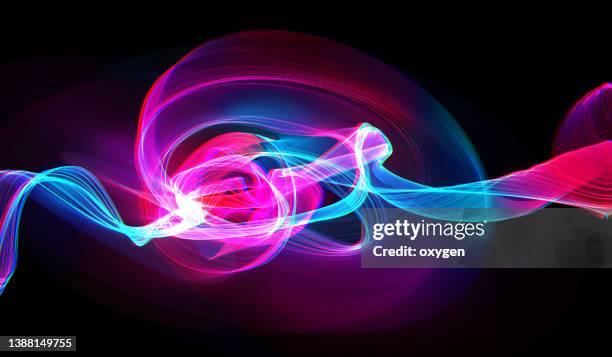 abstract  swirl wave pink blue magical neon transparent ribbon lines on black background. energy streams - slow shutter speed stock-fotos und bilder