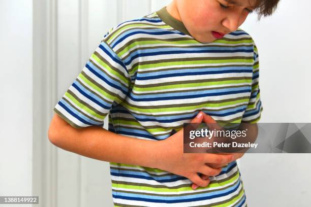 10 year old boy with stomachache - norovirus fotografías e imágenes de stock