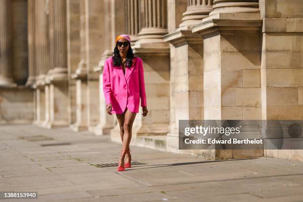 Emilie Joseph @in_fashionwetrust wears black sunglasses, an orange / pink / green / yellow print pattern silk scarf / headcarf from Hermes, a gold...