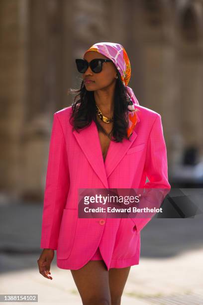 Emilie Joseph @in_fashionwetrust wears black sunglasses, an orange / pink / green / yellow print pattern silk scarf / headcarf from Hermes, a gold...