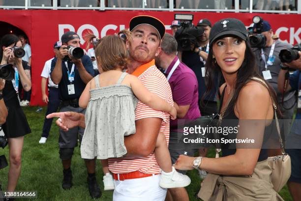 Golfer Rickie Fowler holding his daughter Maya Fowler and with his wife Allison Stokke on July 2 after the final round after winning the Rocket...