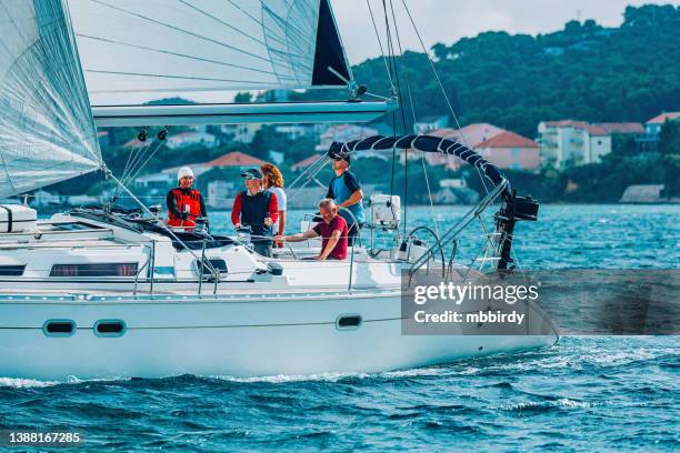 sailing crew on sailboat during regatta - captain yacht stock pictures, royalty-free photos & images