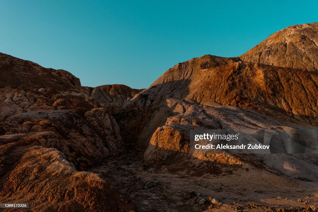 Ural Apocalyptic Surreal unusual landscape, similar to the surface of the planet Mars. Frozen red-brown surface of Chernozem. Barren, cracked and scorched earth and soil. The concept of global warming. Refractory clay quarries. Textured background.