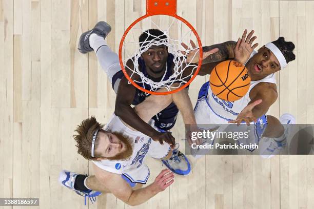 Brady Manek, Armando Bacot of the North Carolina Tar Heels and Fousseyni Drame of the St. Peter's Peacocks battle for a rebound during the Elite...