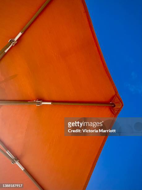 orange sun parasol against bright blue sky - lesser antilles stock pictures, royalty-free photos & images