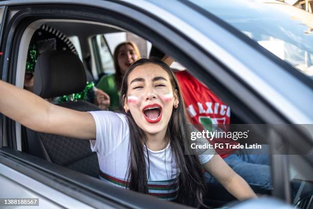 portrait of a teenage latin girl celebrating mexico soccer team win - motorized sport bildbanksfoton och bilder
