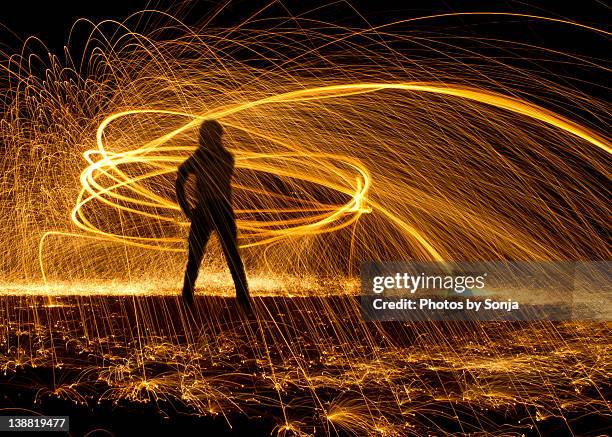 humans making energy - steel wool light painting - light painting stock pictures, royalty-free photos & images