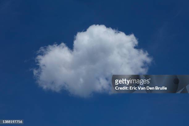 single cloud against blue sky - eric van den brulle stock pictures, royalty-free photos & images