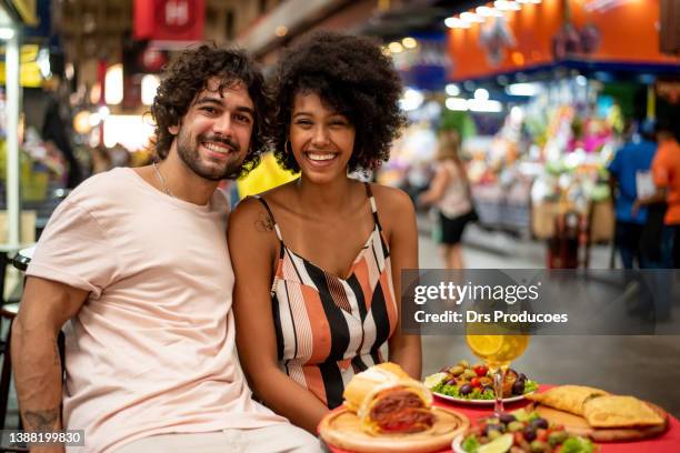 portrait of smiling tourist couple - straight black hair stock pictures, royalty-free photos & images