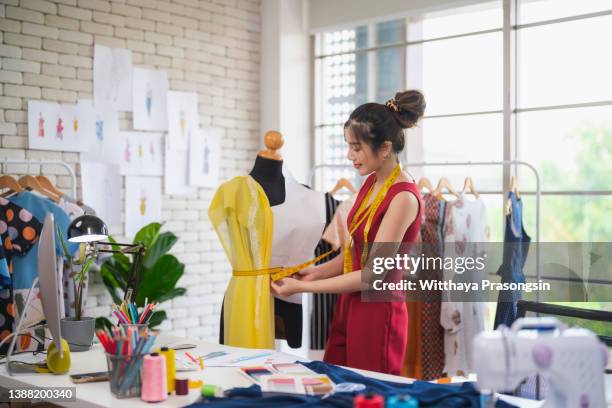 tailors working in studio together - fashion designer stock pictures, royalty-free photos & images