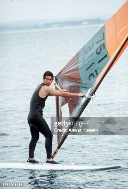 Prince Charles, Prince of Wales has a go at windsurfing on August 06, 1979 in Cowes, Isle of Wight.