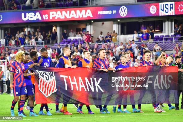 The United States Men's National Team hold up a thank you banner to fans after defeating Panama 5-1 at Exploria Stadium on March 27, 2022 in Orlando,...