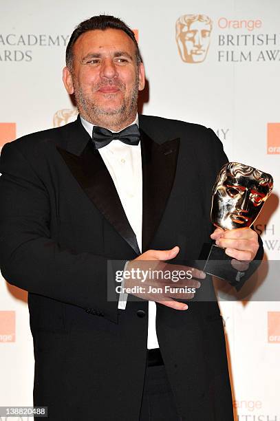 Producer Graham King poses in the press room with the Animated Film award for "Rango" during the Orange British Academy Film Awards 2012 at the Royal...