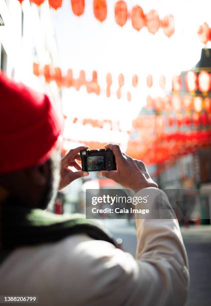 male tourist with digital camera on city street - digital camera stock pictures, royalty-free photos & images