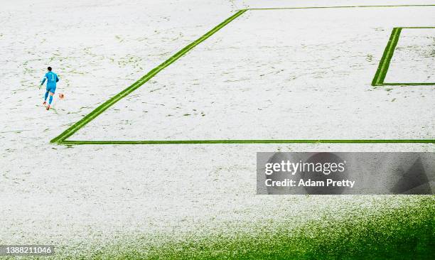 Manuel Neuer of Bayern Muenchen plays the ball outside the box during a snowy Bundesliga match between Bayern and Arminia Bielefeld at Allianz Arena...