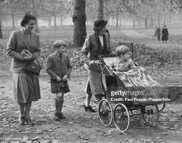 Prince Charles, young son of Princess Elizabeth and Prince Philip, Duke of Edinburgh, seated on right in his pram with Prince Richard of Gloucester...