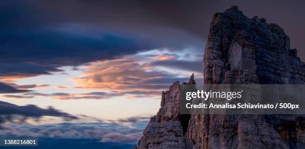 low angle view of rock formation against sky during sunset,cima,italy - escursionismo stock pictures, royalty-free photos & images