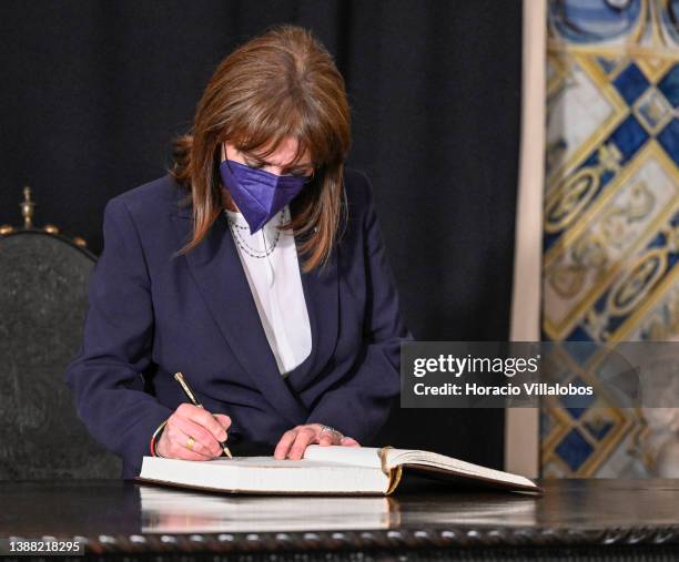 Greek President Katerina Sakellaropoulou signs the honor book in the Presidential Belem Palace during the first day of the Greek President's state...