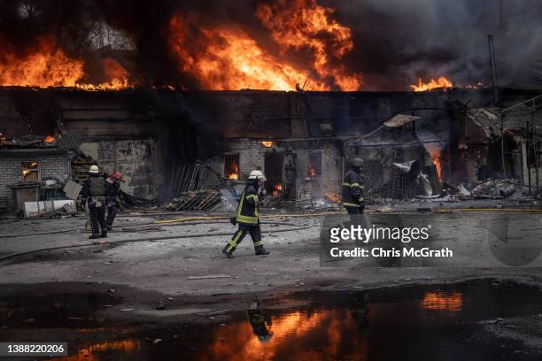 Firefighters work to extinguish a fire at a warehouse after it was hit by Russian shelling on March 28, 2022 in Kharkiv, Ukraine. More than half...