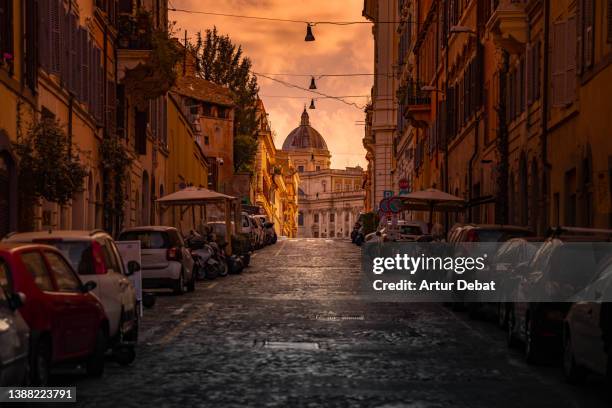 dramatic light in the streets of rome city with church dome. - twilight foto e immagini stock