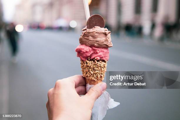 trying tasty ice cream with levels in rome during travel vacations. - gelato stock-fotos und bilder