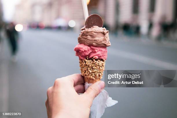 trying tasty ice cream with levels in rome during travel vacations. - アイスクリーム ストックフォトと画像