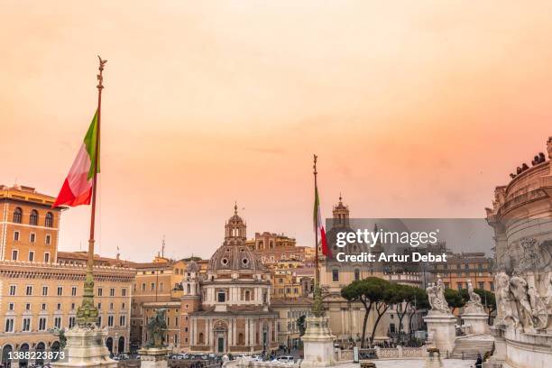 italian flags with the view of rome city during sunset. - ancient roman flag stock pictures, royalty-free photos & images