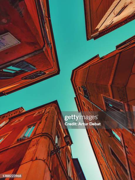 creative geometries looking up with buildings and blue sky in rome. - pointy architecture stock pictures, royalty-free photos & images