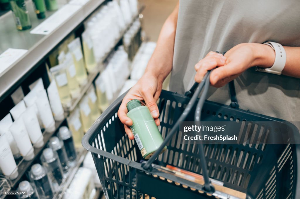 An Unrecognizable Caucasian Woman Buying Some Cosmetic Products