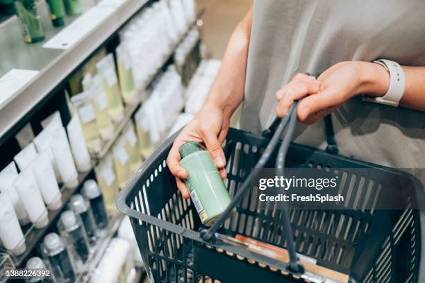 an unrecognizable caucasian woman buying some cosmetic products - hair care bildbanksfoton och bilder