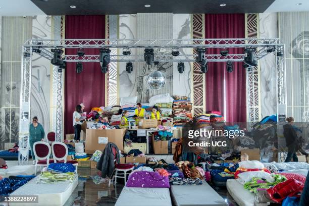 Ukranian refugees at a temporary shelter created inside the big ballroom and reception hall of the luxurious hotel Mandachi, in the Romanian town of...